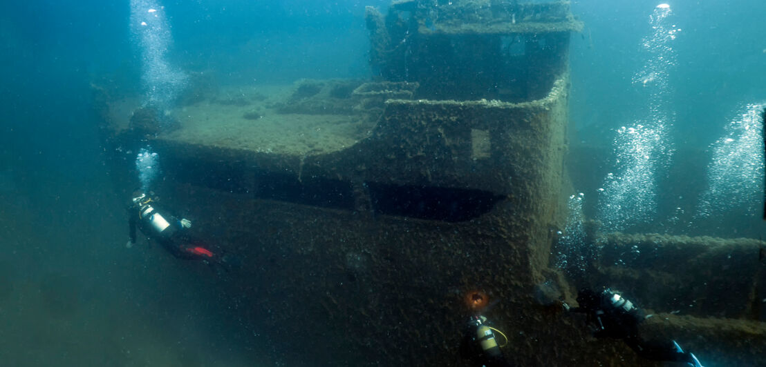 Wracks in der Nähe des Hafens von Palma de Mallorca mit drei Tauchern