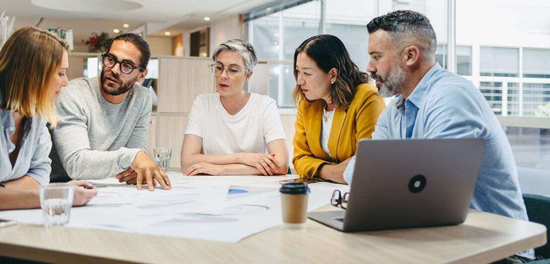 Multicultural designers sharing creative ideas during a meeting in a modern office. Group of innovative businesspeople having a discussion while working on a new project.