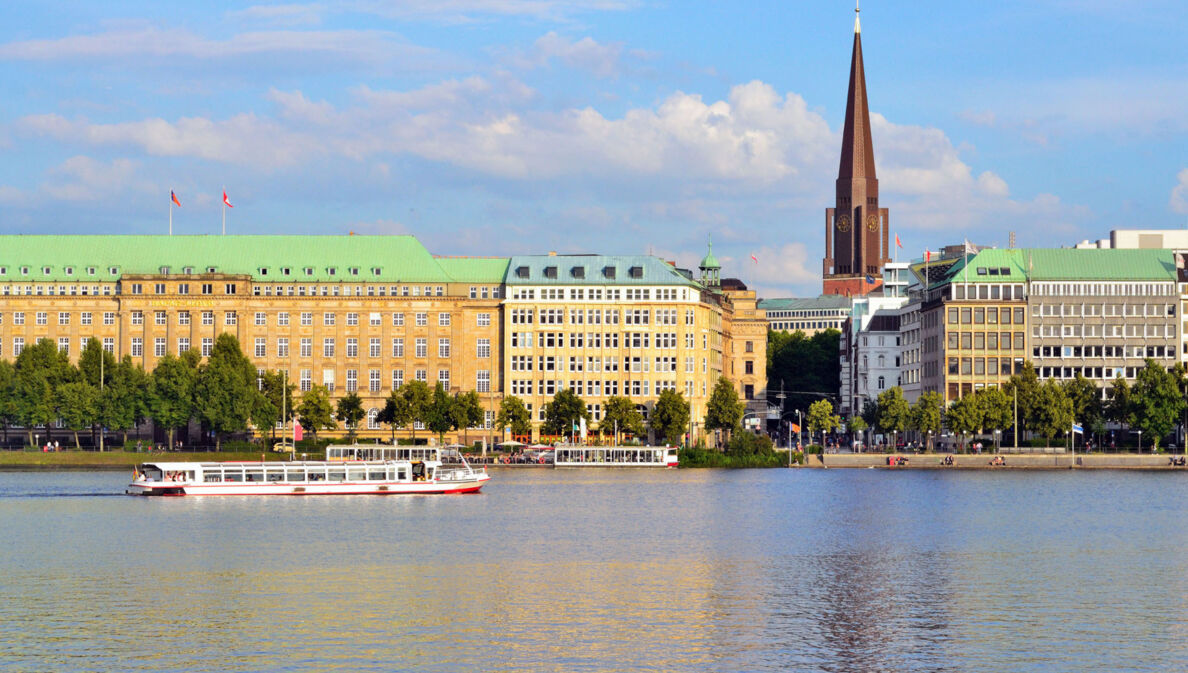 Häuserfront und Promenade am Wasser mit Booten in der Hamburger Altstadt.