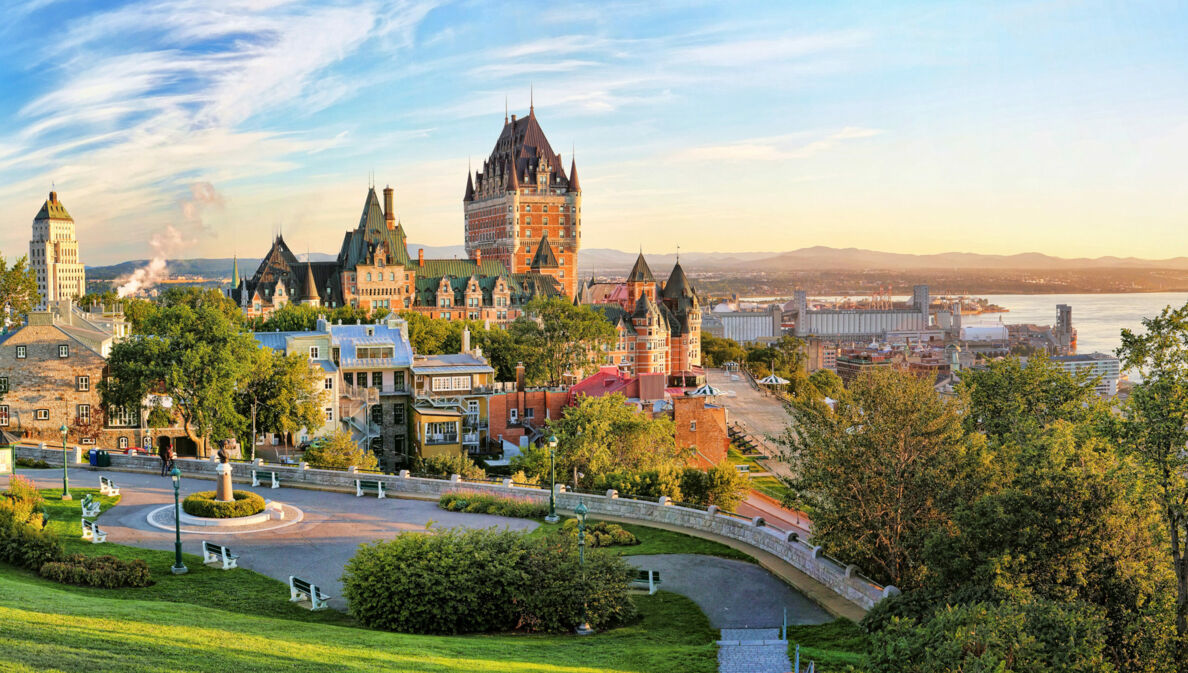 Stadtpanorama von Québec mit Schloss am Wasser, im Vordergrund Parkanlage.