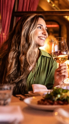 Young friends toasting during dinner in the restaurant