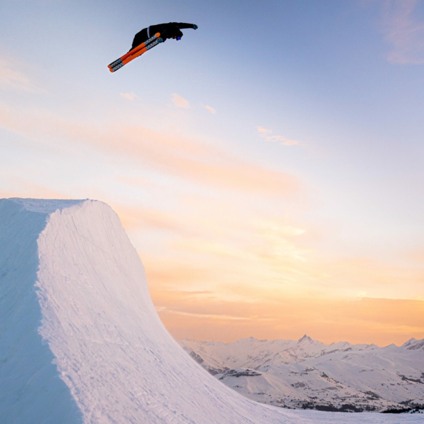 Eine Halfpipe bei Sonnenuntergang mit einem Snowboarder