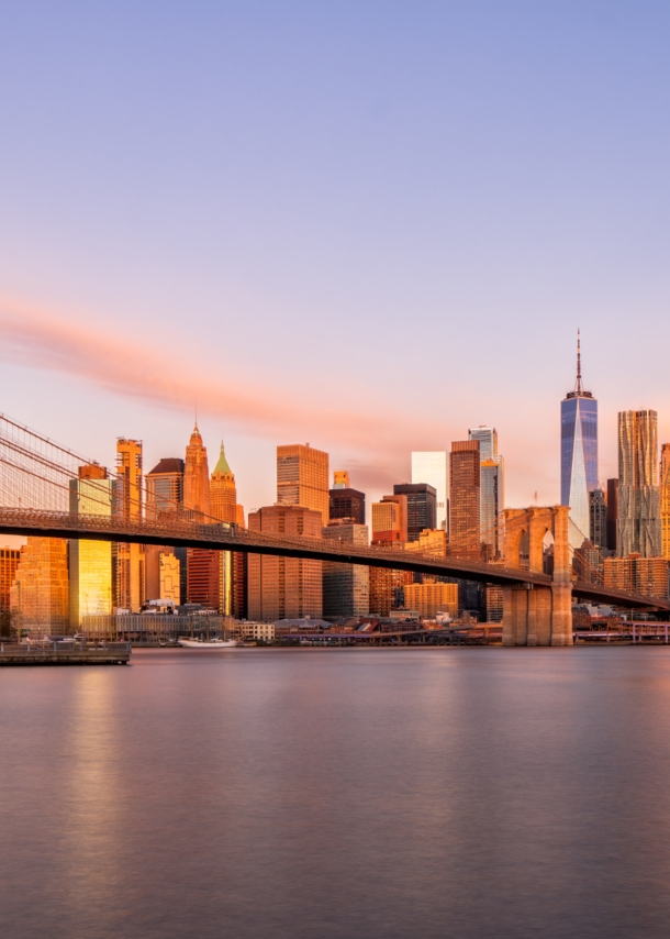 Blick auf die New Yorker Skyline mit Brooklyn Bridge bei Sonnenaufgang