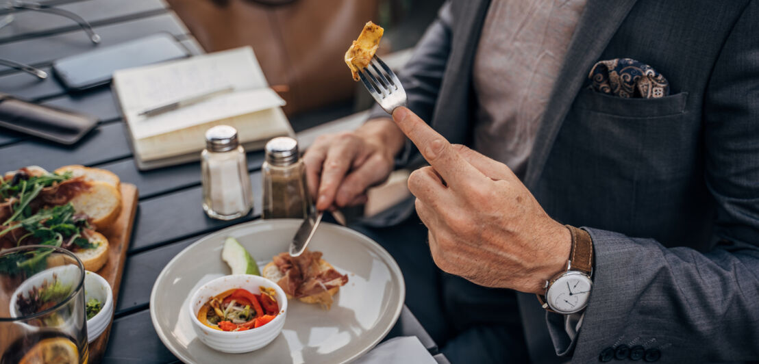 Ein Mann nimmt eine kleine Mahlzeit zu sich