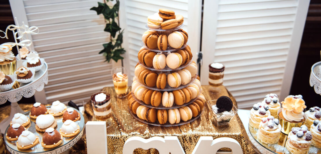 Ein Sweet Table mit Macarons und anderem Gebäck sowie Dessertschalen