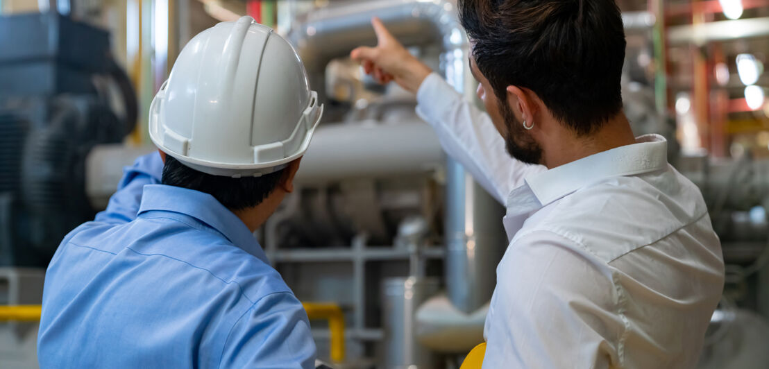 Professional male electrical engineer in safety uniform working