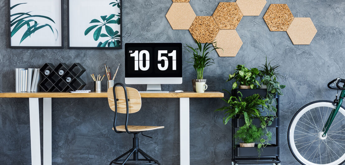 Wood and metal chair standing by the desk in living room with workspace