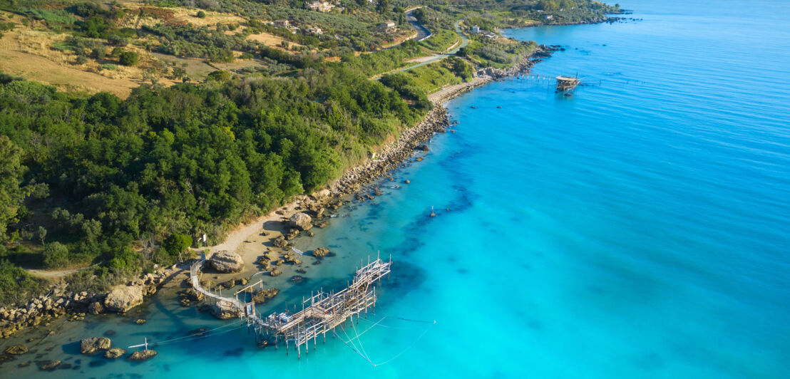 Küstenabschnitt Trabocchi in Italien mit Holzsteg, der ins Wasser ragt Küstenabschnitt Trabocchi in Italien mit Holzsteg, der ins Wasser ragt