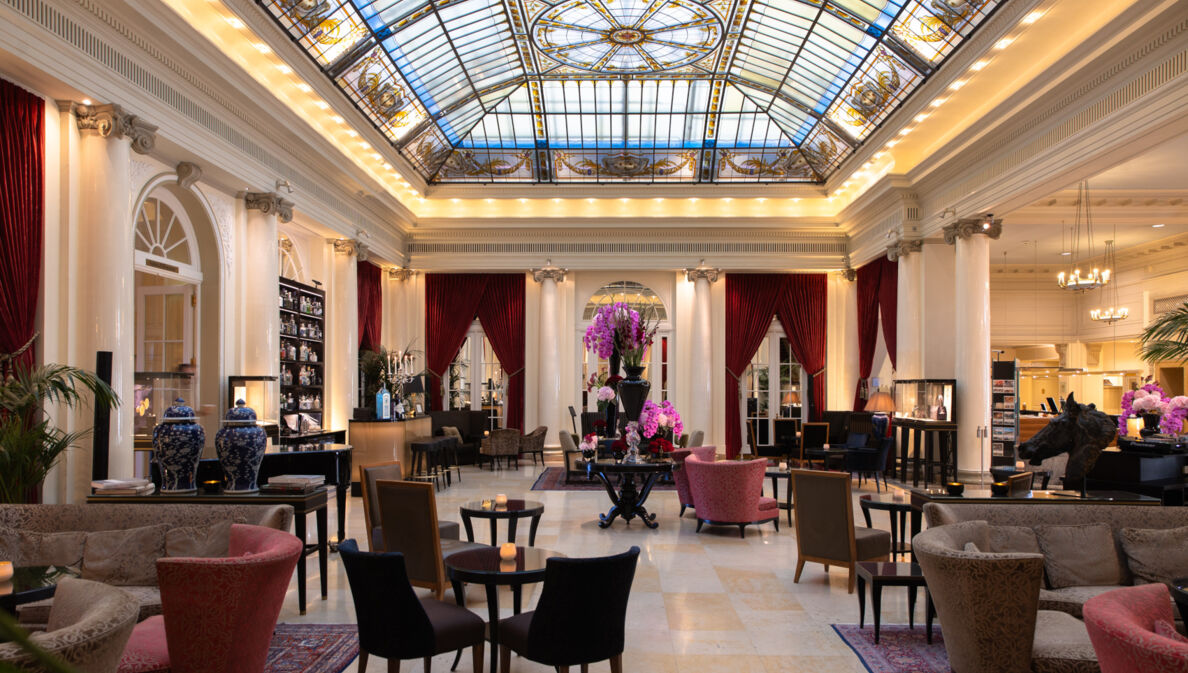 Elegante Hotellobby mit Glasdecke im Jugendstil.