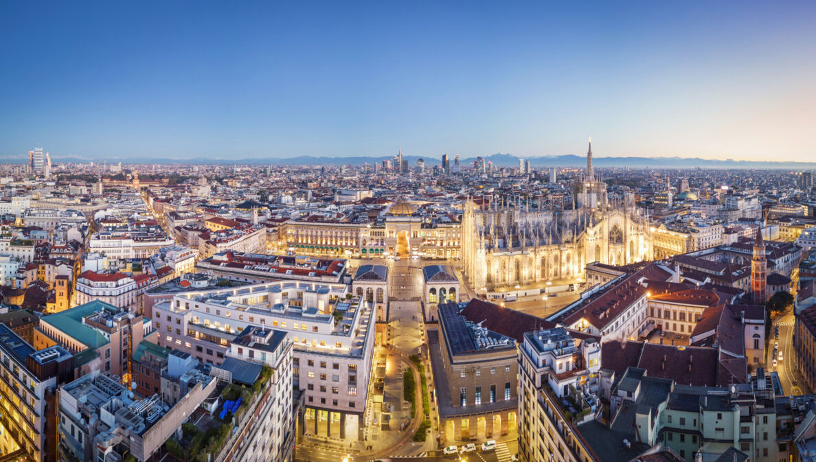 Stadtpanorama von Mailand mit angeleuchtetem Dom aus der Luftperspektive.