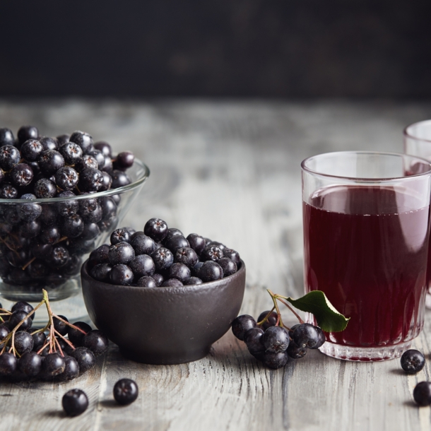 Saft aus Aroniabeeren und Aroniabeeren in Gläsern